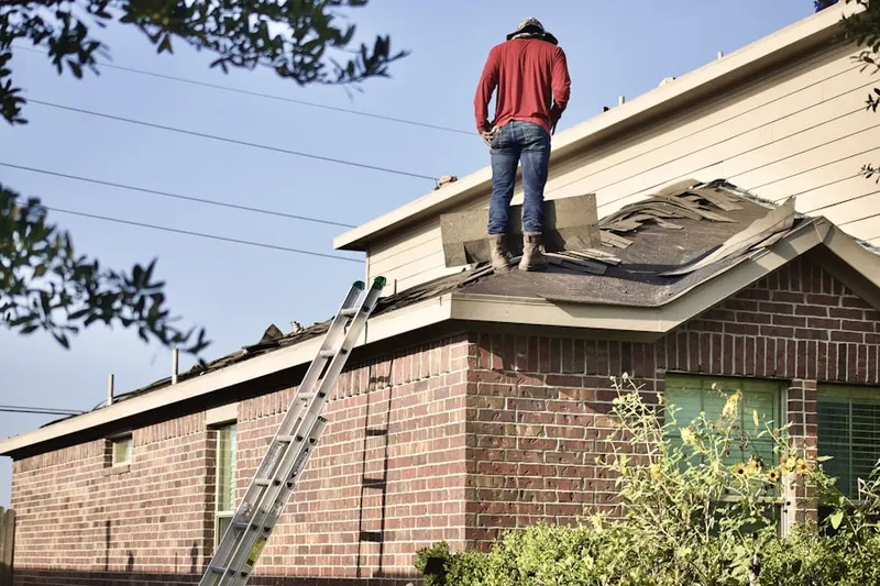 Professional roofer working on a residential roof in South Trail